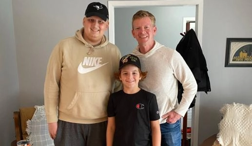 Toronto Blue Jays Central host Jamie Campbell posing with Dylan Gervais and his brother Mason at their home in Penetanguishene Ontario, Canada