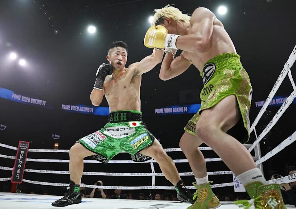Japan's Takuma Inoue, left, trades punches with Tenshin Nasukawa, right, during their WBC bantamweight title bout Monday, Nov. 24, 2025, in Tokyo. (Yusuke Hashizume/Kyodo Photo via AP)