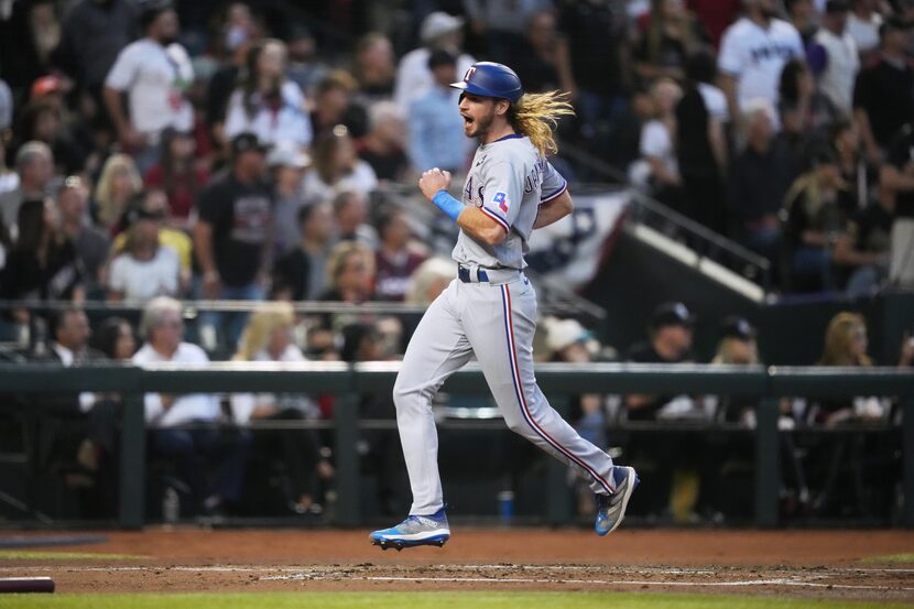 Texas Rangers’ Travis Jankowski (16) scores on a two RBI triple hit by Marcus Semien during...