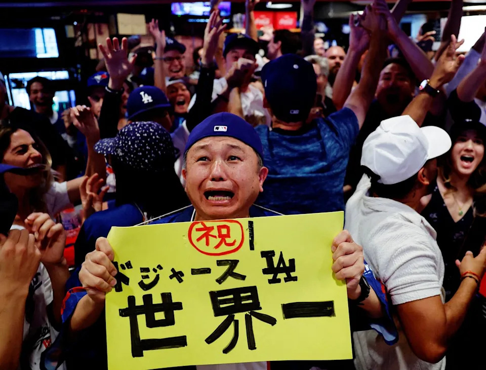 Baseball - MLB World Series - Fans watch Toronto Blue Jays v Los Angeles Dodgers - Tokyo, Japan - November 2, 2025 Fans celebrate after Los Angeles Dodgers won the World Series game against the Toronto Blue Jays at the sports bar Field in Tokyo REUTERS/Kim Kyung-Hoon