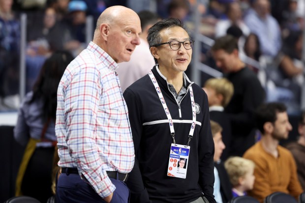 Clippers owner Steve Ballmer, left, speaks with Brooklyn Nets owner Joe Tsai before a preseason game on Tuesday night in Oceanside. (AP Photo/Ryan Sun)