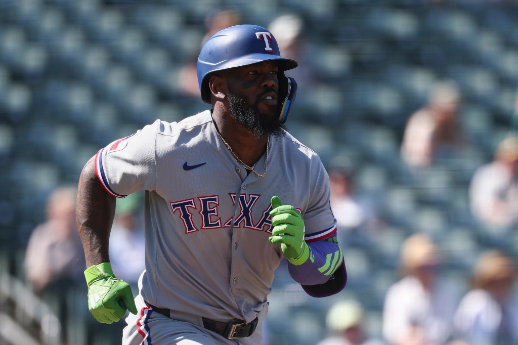 Baseball player Adolis García of the Texas Rangers running.