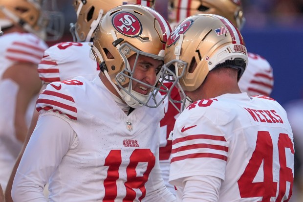 San Francisco 49ers kicker Eddy Piñeiro (18) celebrates with long snapper Jon Weeks (46) after kicking a field goal against the New York Giants during the second quarter of an NFL football game, Sunday, Nov. 2, 2025, in East Rutherford, N.J. (AP Photo/Seth Wenig)
