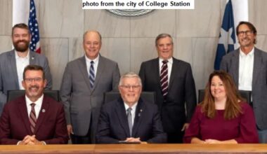 Photo from the city of College Station showing council members (L-R): William Wright, Bob Yancy, Mark Smith, John Nichols (mayor), David White, Melissa McIlhaney, and Scott Shafer.