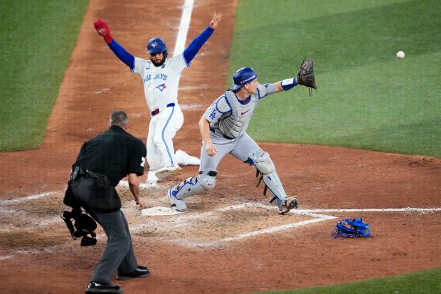 Dodgers catcher Will Smith forces out the Blue Jays' Isiah Kiner-Falefa at home plate for the second out in the ninth inning in Game 7 of the World Series on Saturday, Nov. 2, 2025, in Toronto. (Mark Blinch/Getty Images)