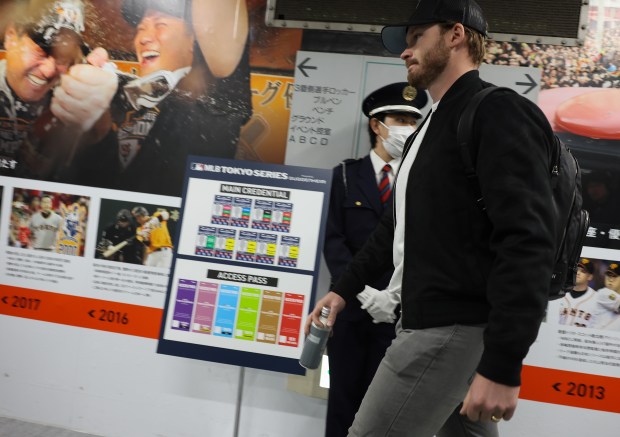 Cubs outfielder Ian Happ walks to the locker room before...