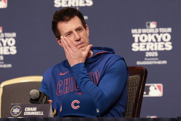 Cubs manager Craig Counsell hears reporters' questions before a team...