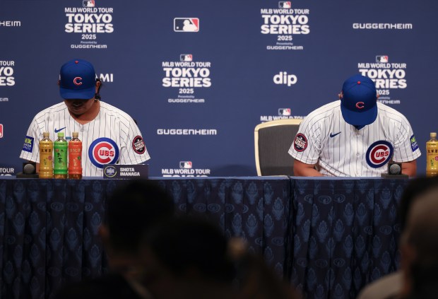 Cubs pitcher Shota Imanaga, left, and outfielder Seiya Suzuki bow...