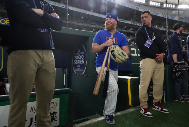 Cubs infielder Justin Turner enters the field for a team...