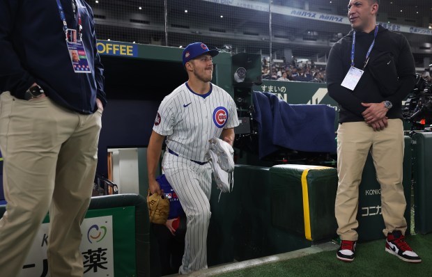 Cubs pitcher Jameson Taillon enters the field for a team...