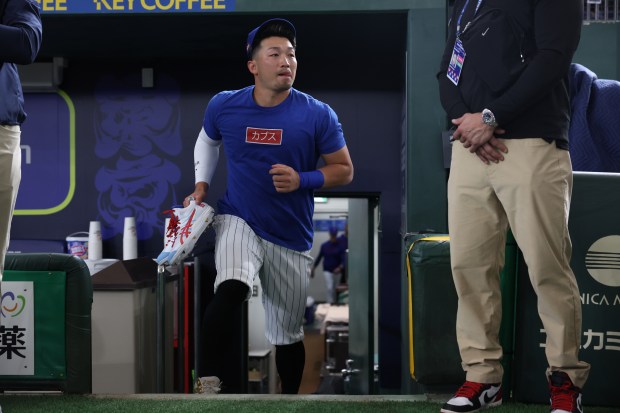 Cubs outfielder Seiya Suzuki enters the field for a team...