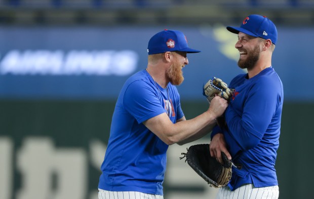 Cubs infielders Justin Turner, left, and Michael Busch laugh while...