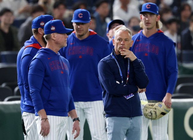 Cubs President of Baseball Operations Jed Hoyer, center right, watches...