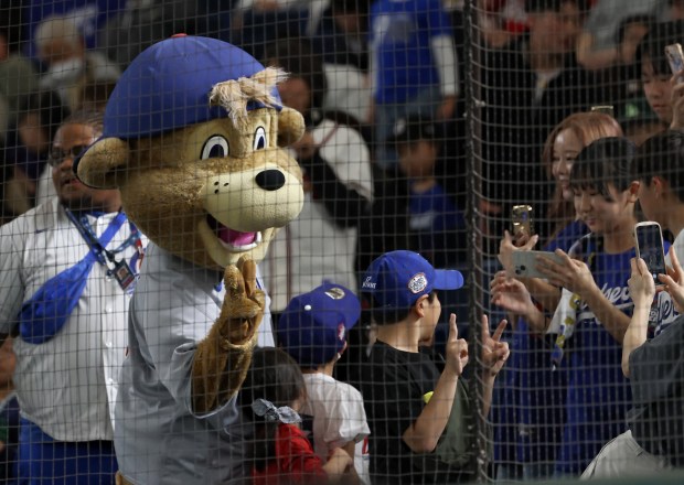 Cubs mascot Clark greets Japanese baseball fans as the team...