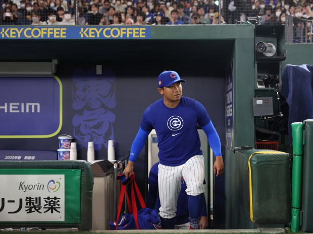 Cubs pitcher Shota Imanaga enters the field for a team...
