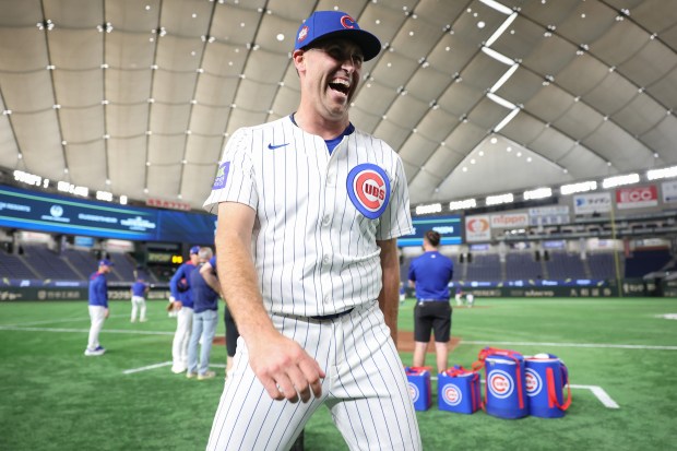 Cubs pitcher Matthew Boyd laughs with teammates during a workout...