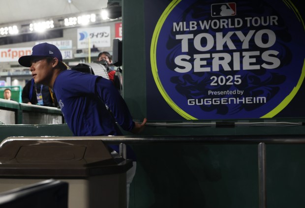 Dodgers pitcher Yoshinobu Yamamoto enters the field to work out...