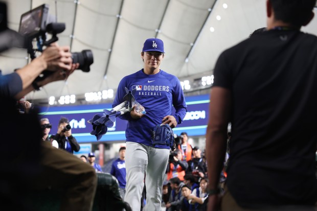 Dodgers pitcher Yoshinobu Yamamoto leaves the field after working out...
