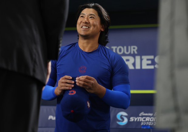 Cubs pitcher Shota Imanaga talks with a colleague before an...