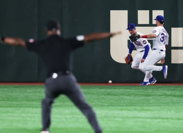 Cubs outfielders Pete Crow-Armstrong and and Kyle Tucker (30) chase...