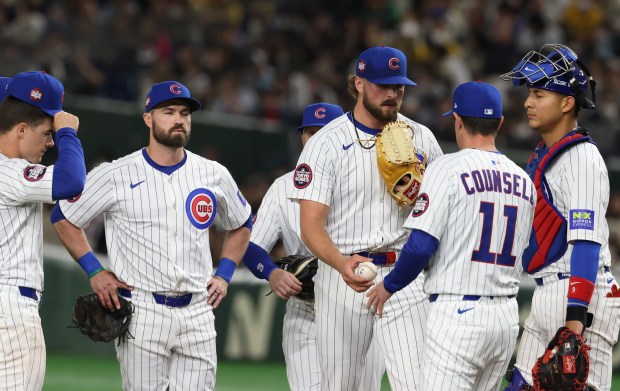 Chicago Cubs pitcher Porter Hodge is taken out of the...