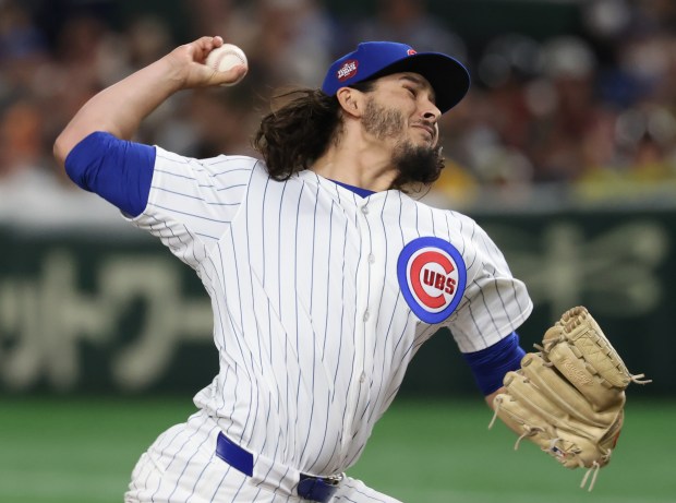 Cubs pitcher Eli Morgan throws against the Hanshin Tigers in...