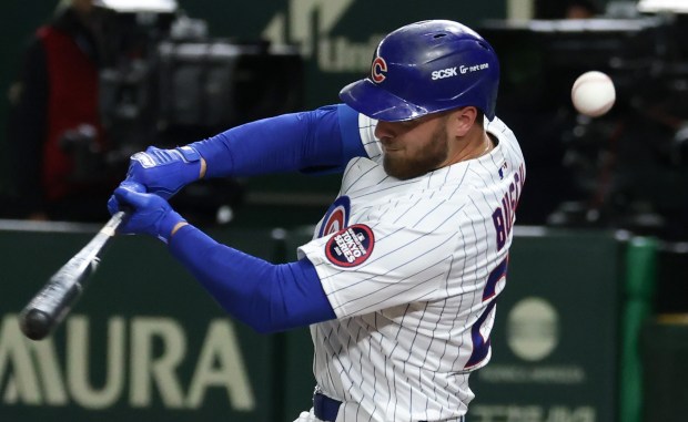 Cubs first baseman Michael Busch fouls off a ball in...