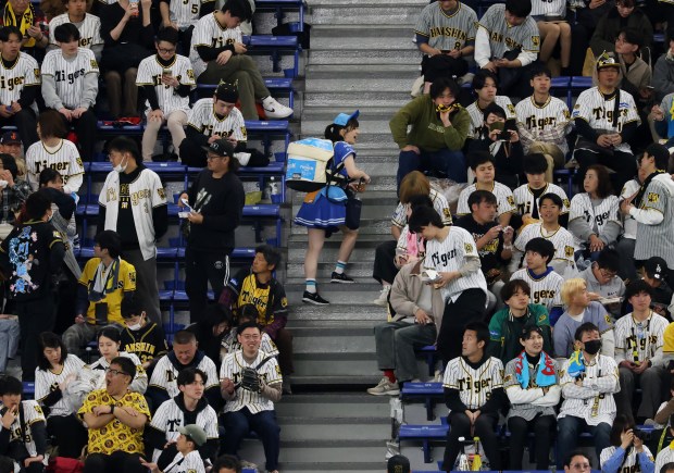 A beer vendor works the right-field bleachers before an exhibition...
