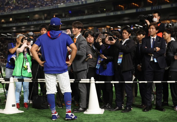 Cubs pitcher Shota Imanaga answers questions from the Japanese press...