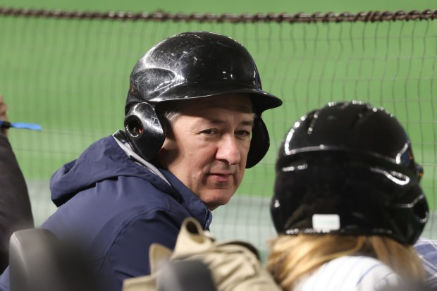 Cubs Chairman and co-owner Tom Ricketts wears a safety helmet...