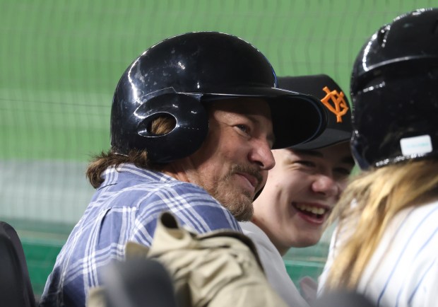 Musician Eddie Vedder wears a safety helmet along the third...