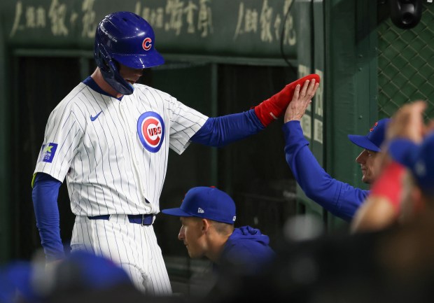 Cubs centerfielder Pete Crow-Armstrong is congratulated by manager Craig Counsell...