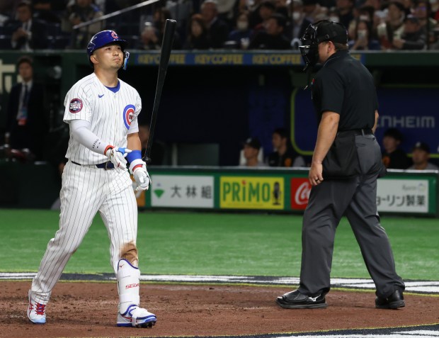 Cubs designated hitter Seiya Suzuki flips his bat after striking...