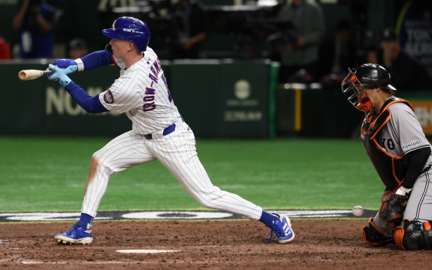Cubs centerfielder Pete Crow-Armstrong checks his swing too late for...