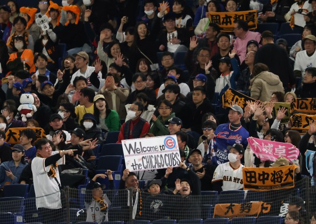 Japanese fans hold up a welcome sign for the Cubs...