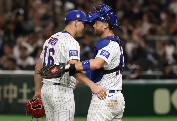 Cubs pitcher Matthew Boyd and catcher Carson Kelly celebrate a...