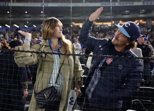 Musician Eddie Vedder and his daughter Olivia celebrate the Cubs'...