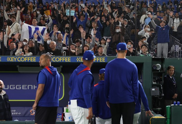 Cubs fans cheer a 4-2 Cubs win over the Yomiuri...