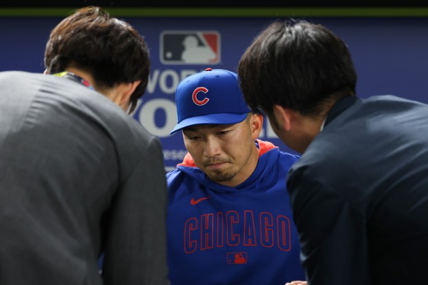 Cubs outfielder Seiya Suzuki is interviewed by reporters before the...