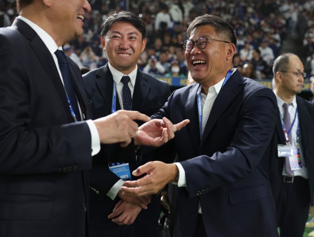 Former Cubs player Kosuke Fukudome, right, laughs with colleagues before...