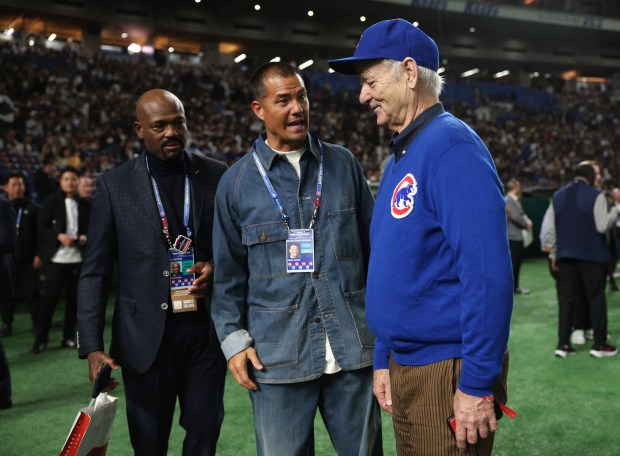Actor Bill Murray, right, listens to men talk before the...