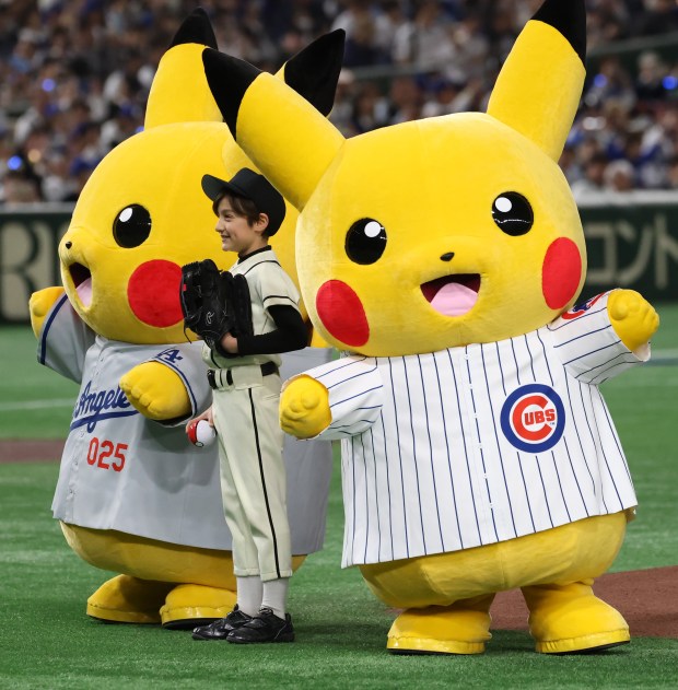 Pokemon characters wear Cubs and Dodgers jerseys for the opening...