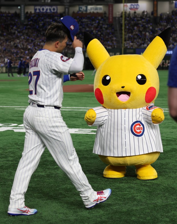 A Pokemon character is dressed in a Cubs jersey as...