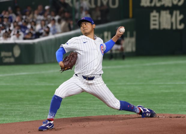 Cubs starting pitcher Shota Imanaga throws against the Dodgers in...