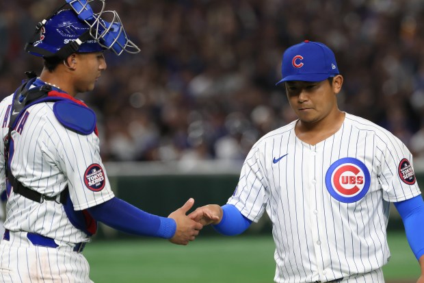 Cubs catcher Miguel Amaya, left, congratulates starting pitcher Shota Imanaga...
