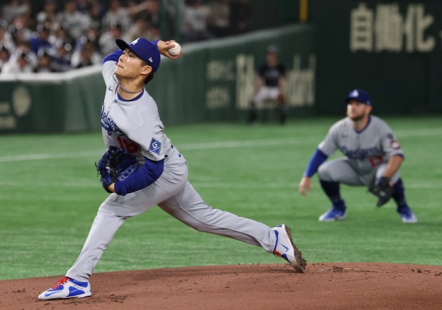 Dodgers starting pitcher Yoshinobu Yamamoto throws against the Cubs in...