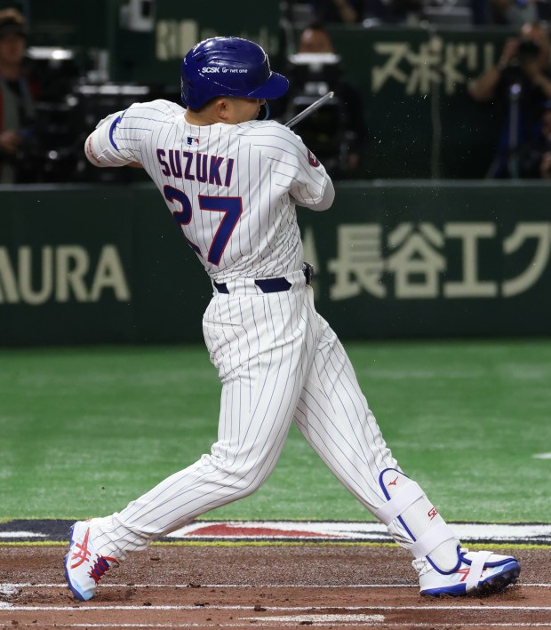Cubs designated hitter Seiya Suzuki breaks the bat on a...