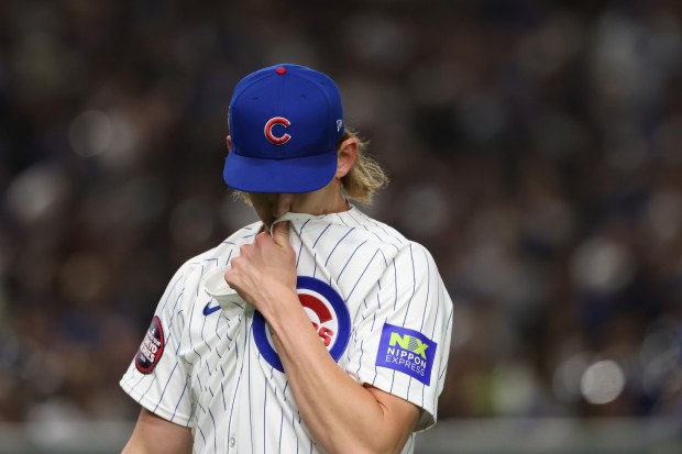 Cubs pitcher Ben Brown heads to the dugout after throwing...