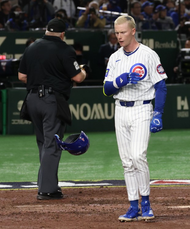 Cubs center fielder Pete Crow-Armstrong tosses his batting helmet after...