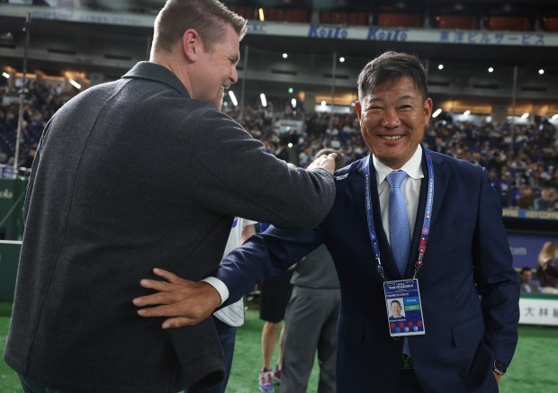 Former Cubs players Kerry Wood, left, and Kosuke Fukudome share...